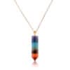 Seven Chakra Point Pendant The Seven Chakra Point Pendant is a gold chain necklace featuring a vertical, hexagonal pendant with stacked purple, blue, green, yellow, orange, and red crystals in a pointed design.