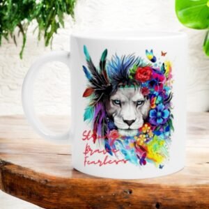 The Strong Brave Fearless Lion Design 11oz Ceramic Mug features a vibrant lion with flowers and feathers in its mane and the words “Stay Brave Fearless” in red script on the side.