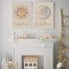 The Live By The Sun & Love By The Moon Prints hang above a white mantle, each featuring sun and moon designs. Decorative toys, animals, and a rainbow complete the charming display.