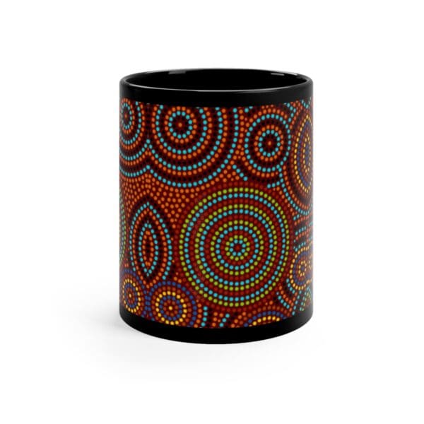 The Aboriginal Dot Art Printed Mug features a vibrant dot painting with concentric circles and patterns in blue, green, yellow, orange, and red on a black background.