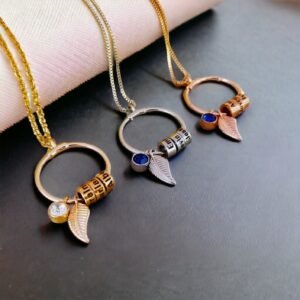 Three Birthstone Leaf Personalised Bead Necklaces in gold, silver, and rose gold feature a circular pendant with a birthstone, leaf charm, and lettered beads. All are displayed on black and pink surfaces.