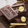 A wooden box engraved with STEVE, BEST MAN, 05.13.2024 sits beside the Personalised Cufflinks and Tie Clip Gift Set, both engraved with S|R, on a wooden surface—an elegant personalised gift for special occasions.