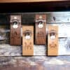 Wall Mounted Bottle Opener Personalised Gift Four Wall Mounted Bottle Opener Personalised Gifts, each engraved with a unique name and decorative initial, featuring metal openers and rustic wooden backing—a thoughtful customised present for any occasion.