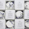A grid of boxed Inner Peace Individual Shower Steamers—each round, white tablet topped with dried blue and yellow petals—displayed neatly in white packaging.