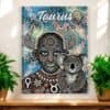 The Taurus Bull Horn Man with Koala Aboriginal Zodiac Dot Art Canvas Copy hangs on a white wall between two green potted plants, featuring vibrant artwork in a stylized dot art design.
