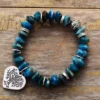 blue apatite stone bracelet with siver heart shaped charm featuring iimage of the tree of life