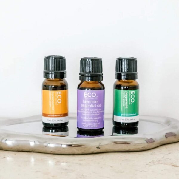 Virgo Essential Oil Blend Three bottles from the Classic Essentials Trio Essential Oil Pack—orange, lavender, and peppermint—are displayed on a shiny silver tray against a white background.