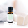 ECO Little Sniffles Essential Oil Blend A 10ml (0.30 fl oz) amber bottle of ECO Little Sniffles Essential Oil Blend rests on a white block, with a blurred beige cup in the soft background.