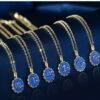 Copper Micro-inlaid Zodiac Couple Necklace Six Copper Micro-inlaid Zodiac Couple Necklaces with blue circular pendants, each showing a unique zodiac sign, are neatly arranged on a dark blue velvet background.
