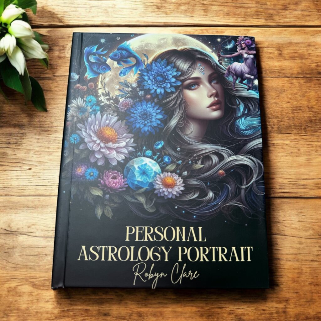 YOUR BIRTH MOON PHASE & PERSONALITY TRAITS A Personalised Birth Chart Astrology Book rests on a wooden surface. Its cover depicts a mystical woman adorned with flowers and astrological symbols, reflecting the vibrant, cosmic style of this unique astrology book.