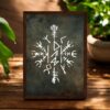 Viking Stave For Dad Wooden Framed or Print Only The Viking Stave For Dad Wooden Framed Print features a white, detailed Viking stave design on a dark textured background, framed in wood and displayed on a wooden surface with green plants beside it.
