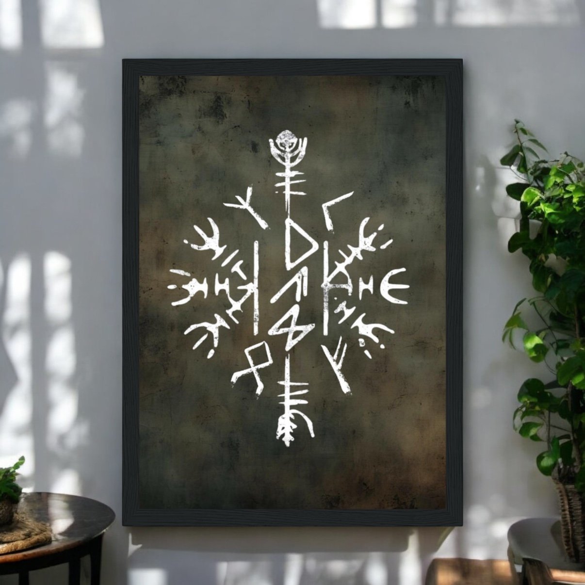 The Viking Stave For Dad Wooden Framed Print features a white Norse symbol on a dark, textured background—perfect for hanging amidst sunlight and green plants, making it a unique and thoughtful gift for Dad.