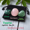 Taurus birthstone crystals , Emerald, Rose Quartz and Green Aventurine tumble stones on a black drawstring gift bag, sitting on a white timber table.